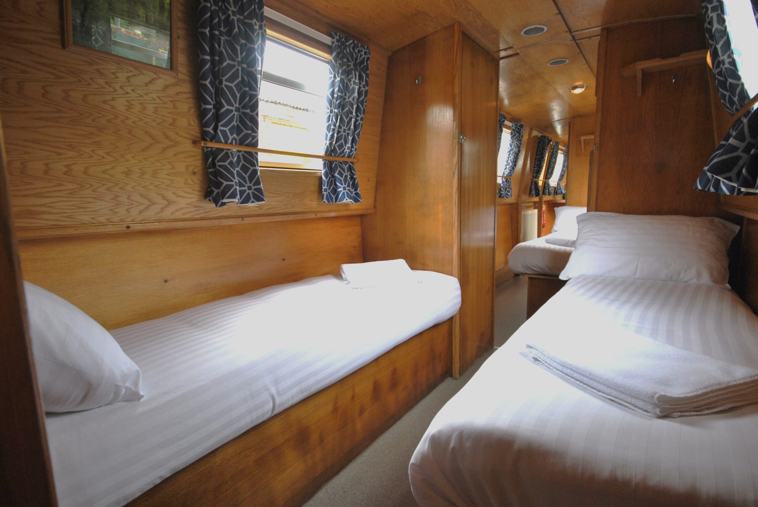 King size bed on a narrow canal boat